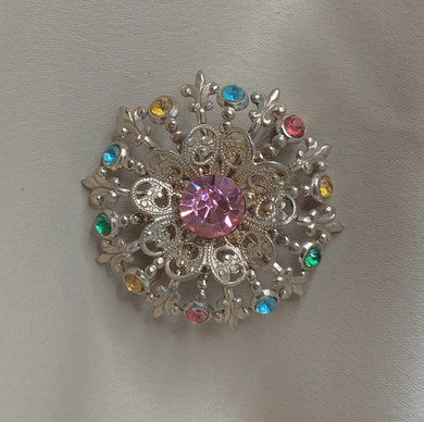 Gold tone, round multi colour brooch.