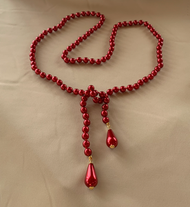 42" glass, deep red sautoir pearls teardrop ends w/gold RENTAL